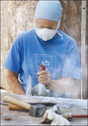 Woodson granite project continues as Liberia RPCV Susan Falkman chisels with her own style